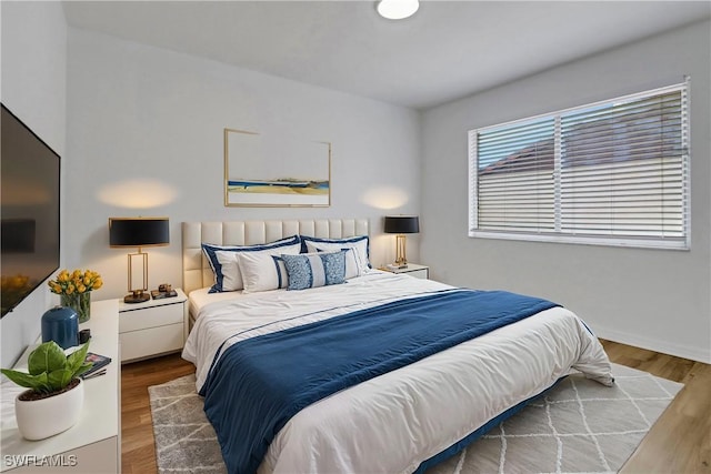 bedroom with hardwood / wood-style flooring