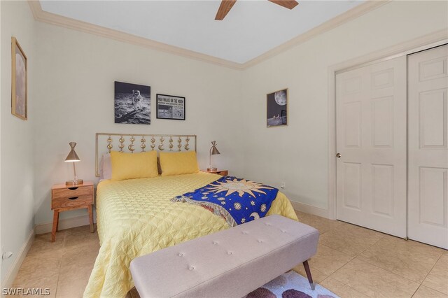 bedroom featuring ceiling fan, light tile patterned floors, crown molding, and a closet