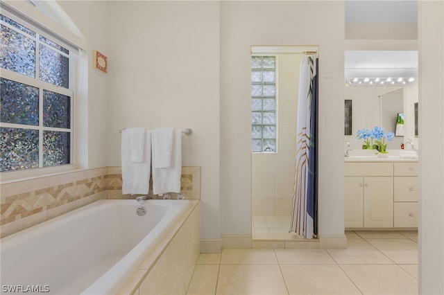 bathroom featuring tile patterned floors, vanity, and separate shower and tub