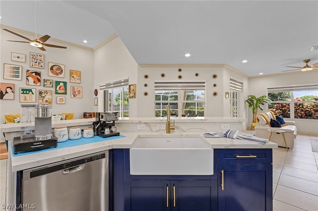 kitchen featuring a healthy amount of sunlight, sink, stainless steel dishwasher, and blue cabinets