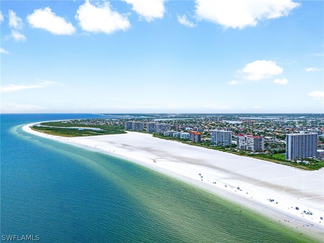 drone / aerial view with a water view and a beach view