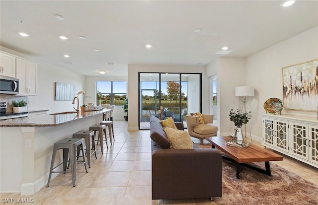 living room with light tile patterned floors and sink