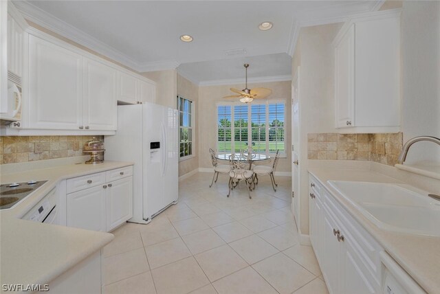 kitchen featuring sink, white appliances, crown molding, white cabinetry, and decorative light fixtures