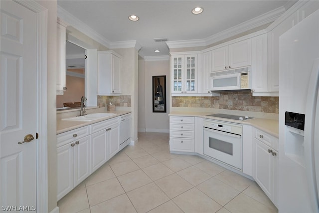 kitchen with sink, white appliances, white cabinets, and crown molding