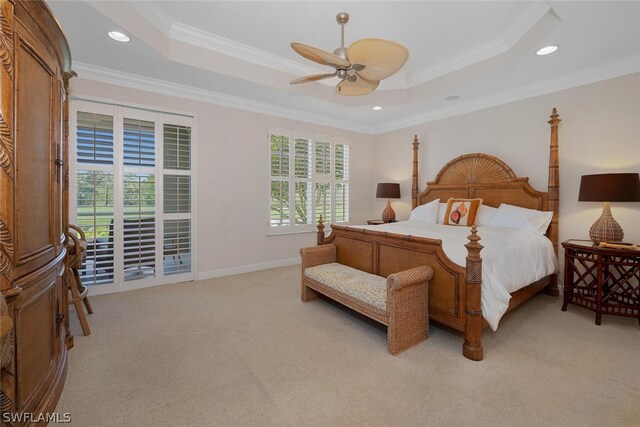 carpeted bedroom featuring crown molding, access to exterior, ceiling fan, and a tray ceiling