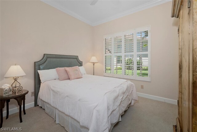 carpeted bedroom featuring crown molding and ceiling fan