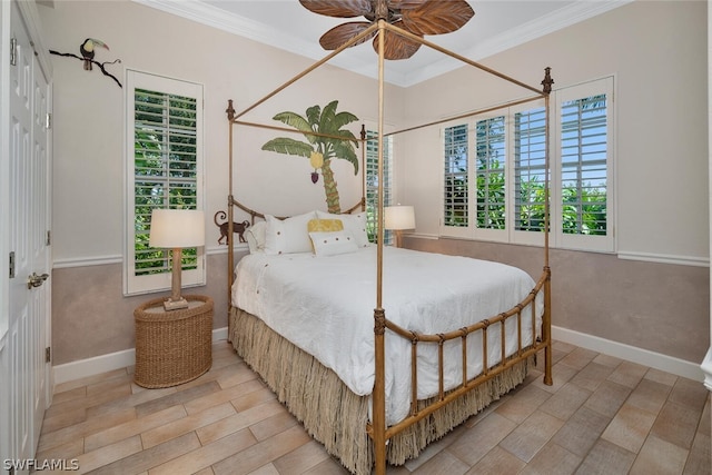 bedroom featuring ceiling fan, crown molding, and multiple windows