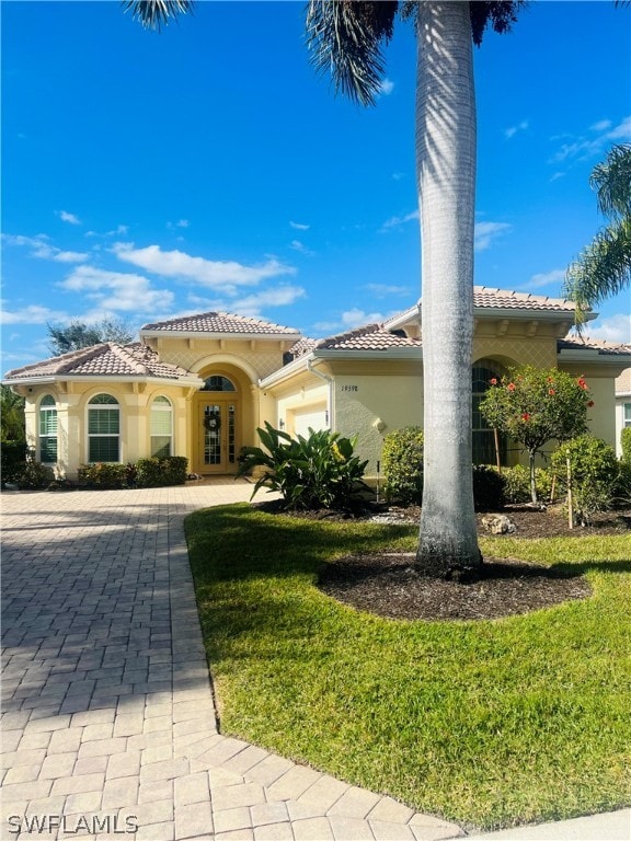 mediterranean / spanish house featuring a front lawn