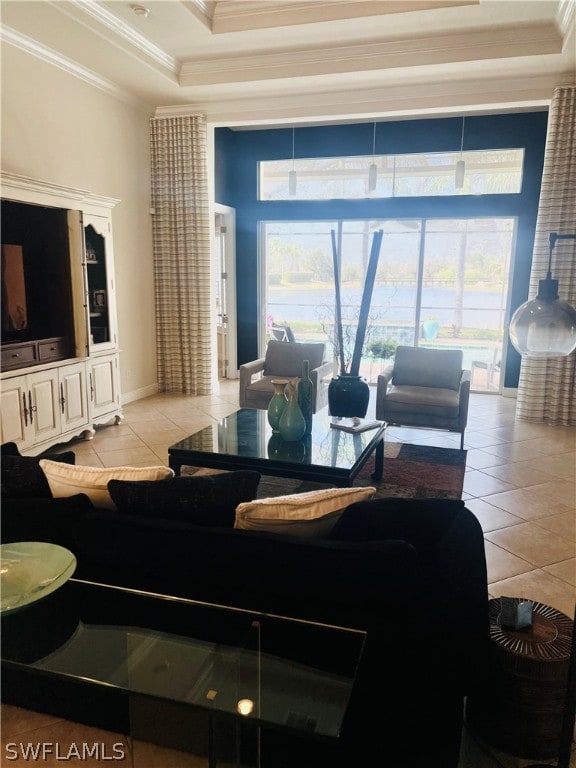 tiled living room featuring a raised ceiling and ornamental molding