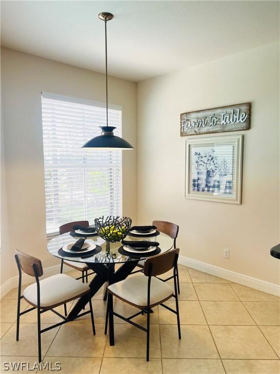 dining space featuring light tile patterned floors