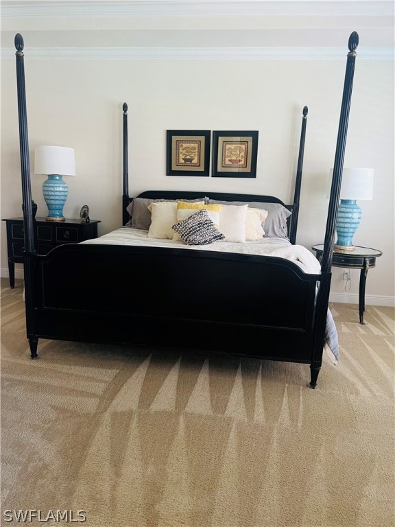 carpeted bedroom featuring crown molding