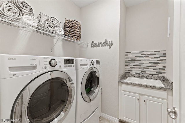 washroom with cabinets, sink, and separate washer and dryer