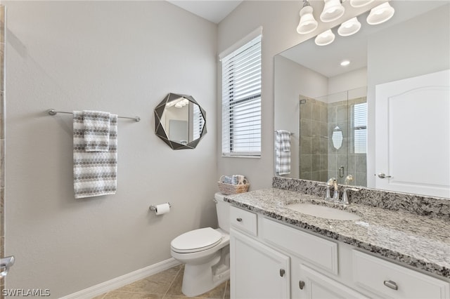 bathroom with toilet, tile patterned flooring, a shower with shower door, and vanity