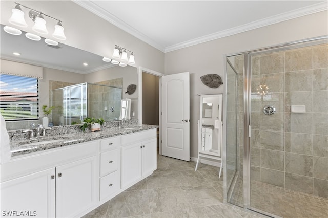 bathroom featuring an enclosed shower, vanity, and ornamental molding