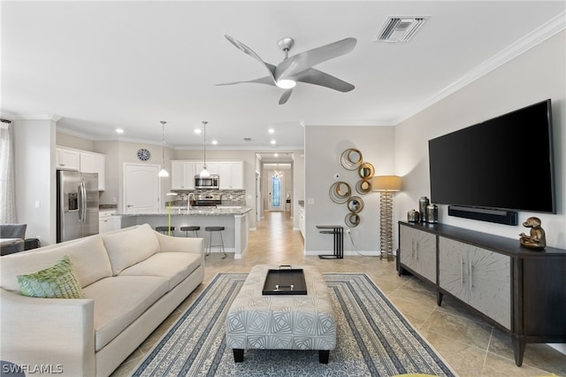 living room featuring ceiling fan and ornamental molding