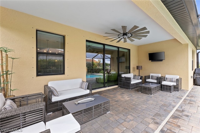 view of patio with ceiling fan and an outdoor living space