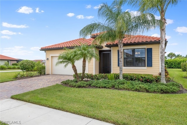 mediterranean / spanish home with a front lawn and a garage