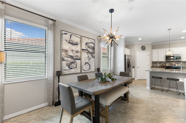 dining space featuring ornamental molding, a healthy amount of sunlight, and an inviting chandelier