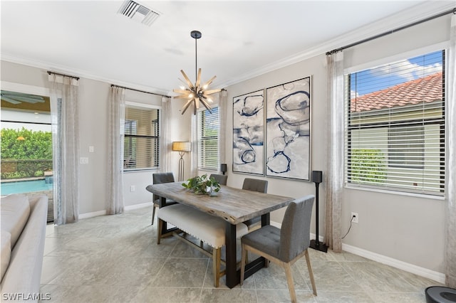 dining space featuring ornamental molding and an inviting chandelier