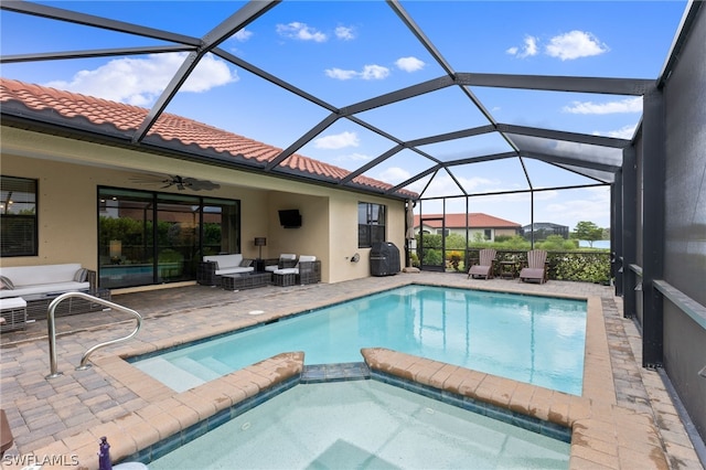 view of pool with glass enclosure, ceiling fan, a patio area, outdoor lounge area, and area for grilling