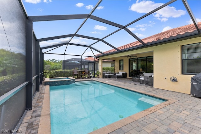 view of swimming pool featuring a lanai, outdoor lounge area, an in ground hot tub, and a patio