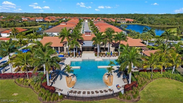 view of pool featuring a patio area and a water view