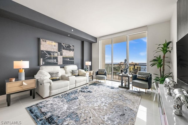 living room featuring tile patterned flooring and a wall of windows