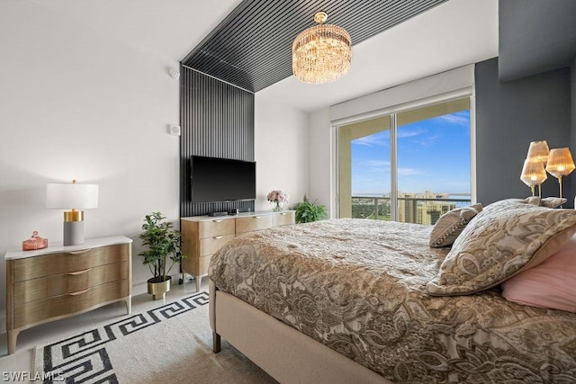 bedroom with access to exterior, carpet, and an inviting chandelier