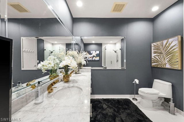 bathroom featuring toilet, a sink, visible vents, and a shower stall