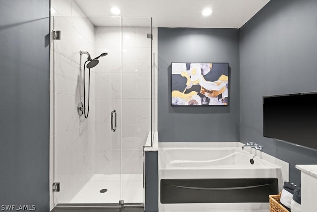 full bath with recessed lighting, a garden tub, and a shower stall