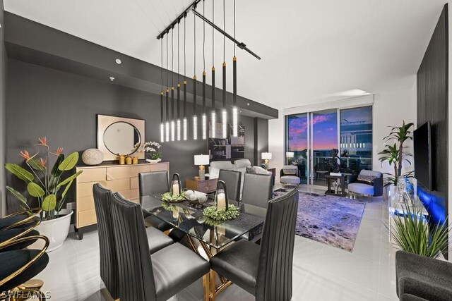 tiled dining room featuring floor to ceiling windows