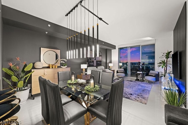 tiled dining area featuring a wall of windows