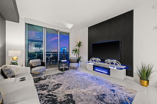 3000 Oasis Grand Blvd Unit Mph3, Fort Myers, FL 33916 - living area featuring tile patterned flooring and a glass covered fireplace