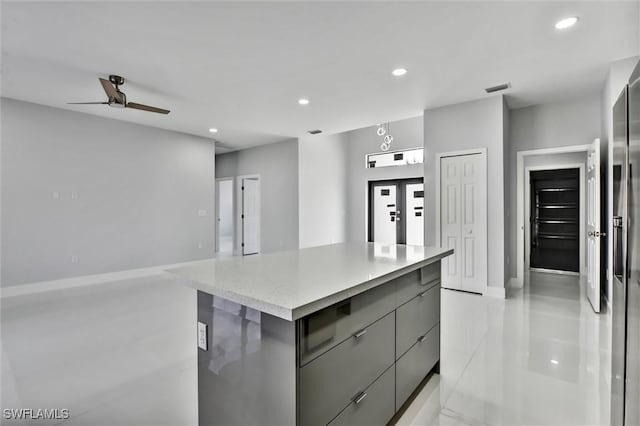 kitchen with modern cabinets, recessed lighting, gray cabinets, and a center island