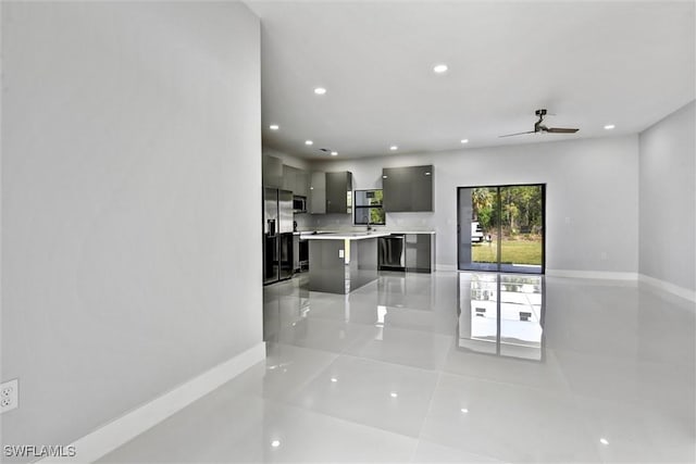 living area with light tile patterned floors, recessed lighting, baseboards, and a ceiling fan