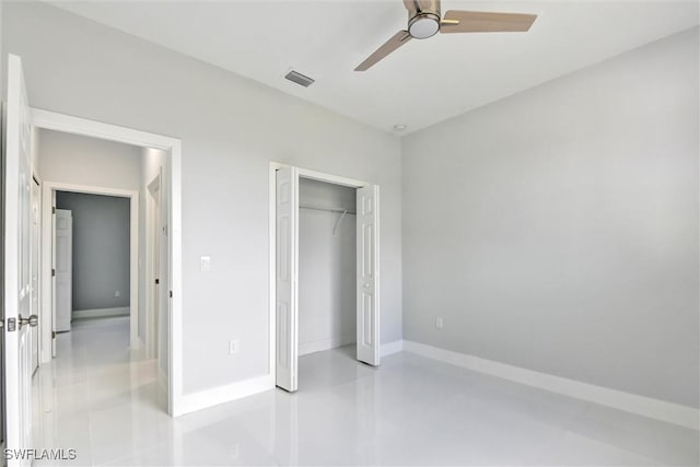 unfurnished bedroom featuring visible vents, finished concrete flooring, baseboards, a closet, and a ceiling fan