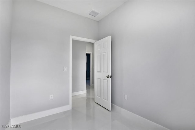 unfurnished room with baseboards, visible vents, and concrete floors