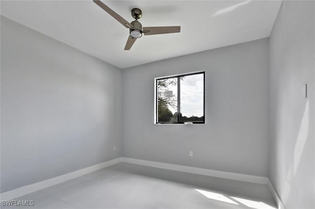 empty room featuring finished concrete floors, baseboards, and a ceiling fan