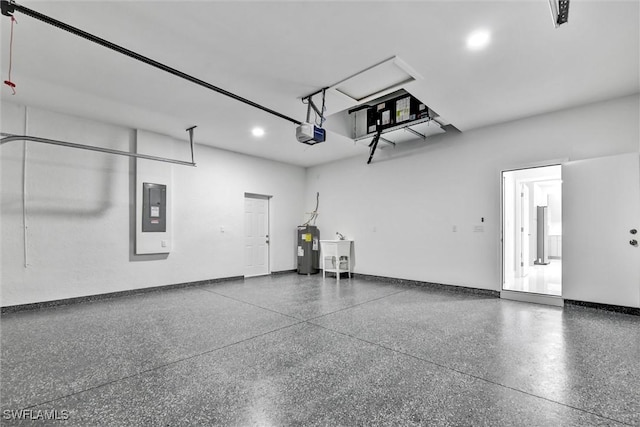 garage with baseboards, water heater, electric panel, a garage door opener, and a sink