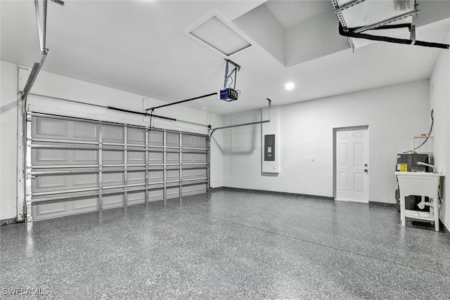 garage with electric panel, a garage door opener, and baseboards