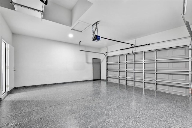 garage featuring a garage door opener and baseboards