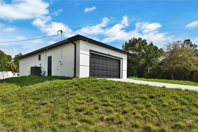 detached garage featuring central AC unit