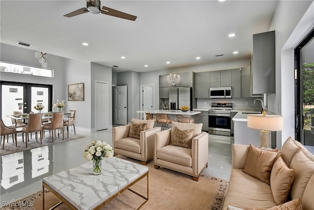 living area featuring recessed lighting and visible vents