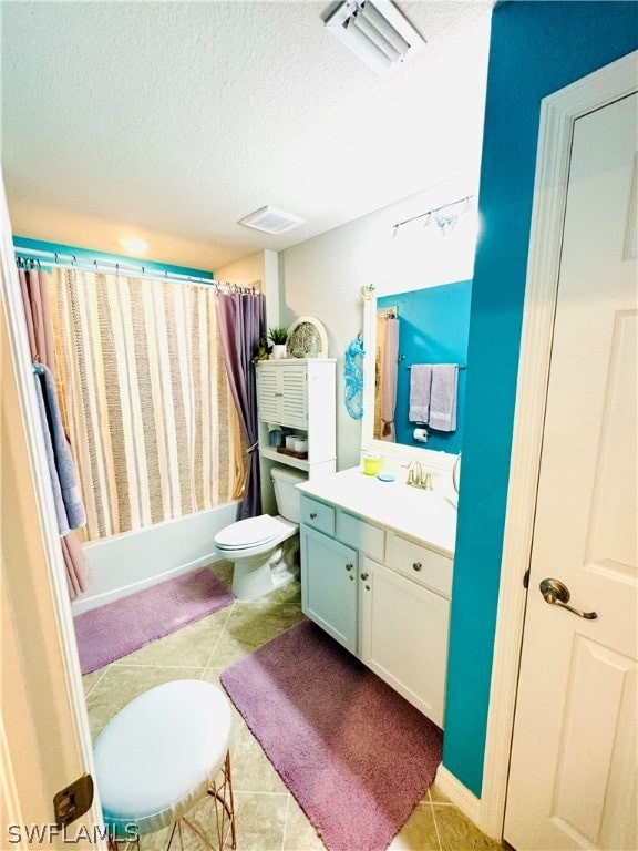 full bathroom featuring a textured ceiling, shower / bath combination with curtain, toilet, vanity, and tile patterned flooring