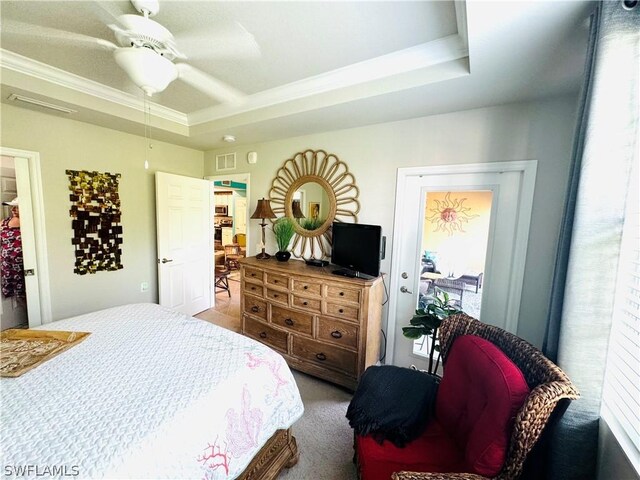 bedroom featuring ornamental molding, ceiling fan, carpet flooring, and a raised ceiling