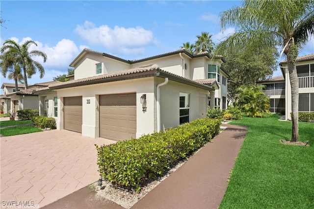 view of side of property with a lawn and a garage