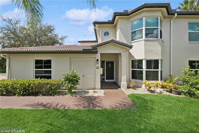 view of front of property with central AC and a front yard