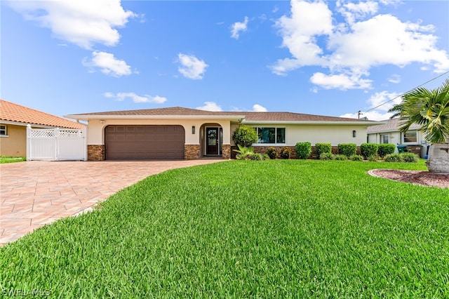 view of front of house featuring a garage and a front lawn