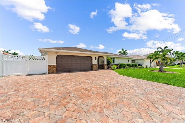 view of front of property featuring a front yard and a garage