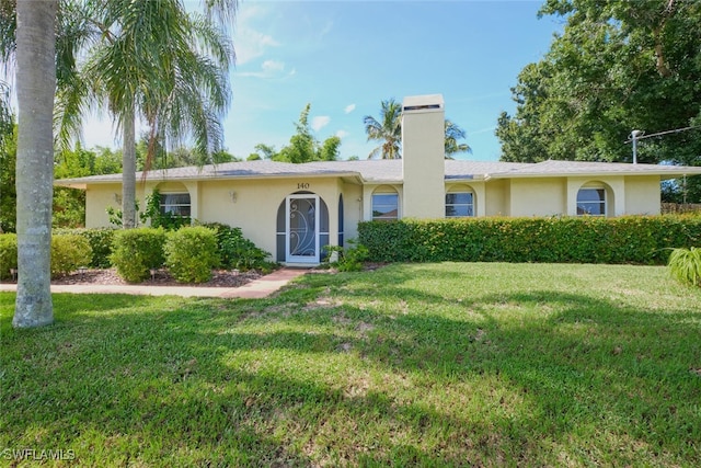 single story home with a front lawn